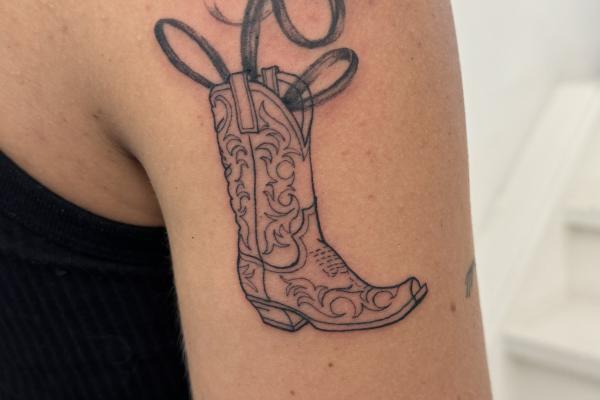 Fineline Cowgirl Boot Tattoo With Abstract Flower