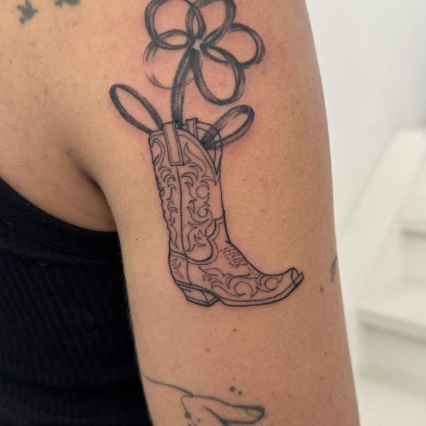 Fineline Cowgirl Boot Tattoo With Abstract Flower