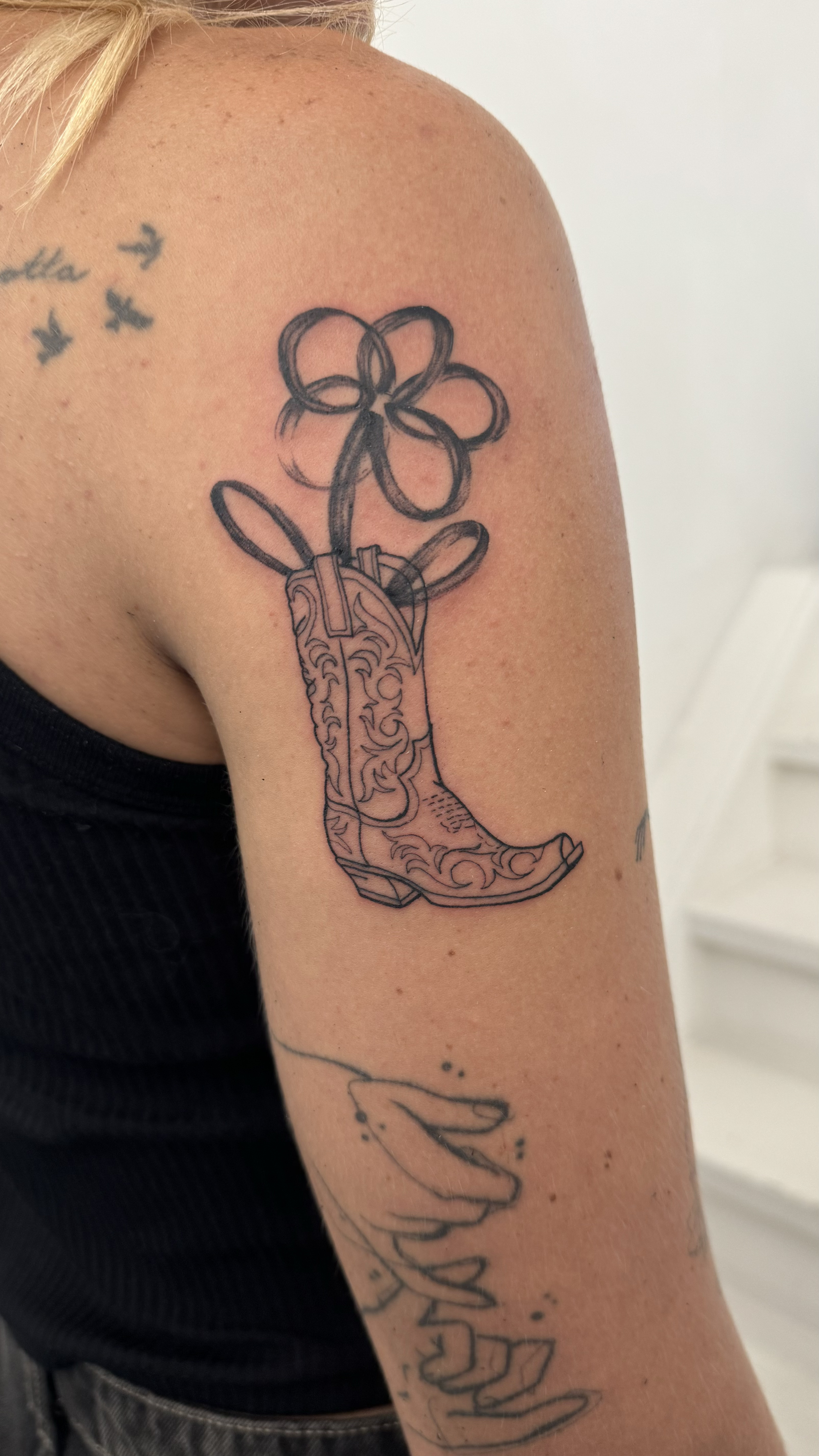 Fineline Cowgirl Boot Tattoo With Abstract Flower